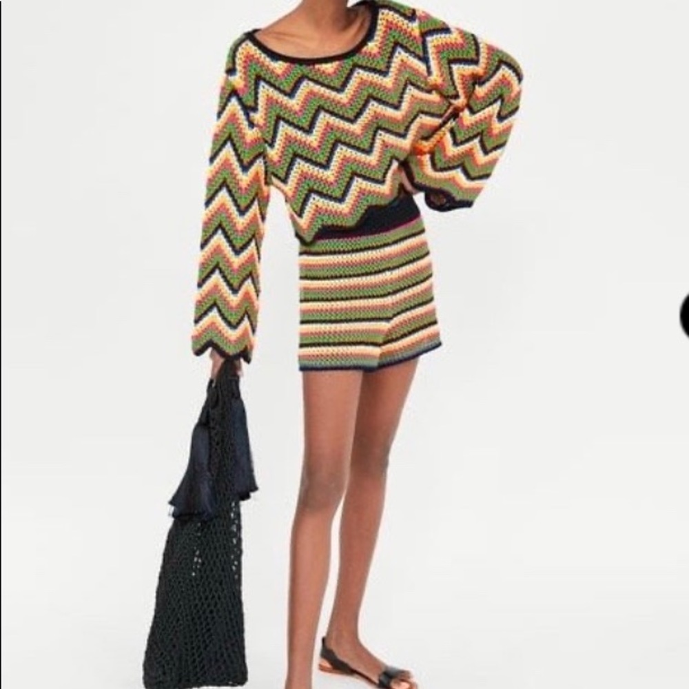 Multicolored crochet sweater and shorts.